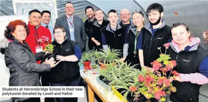  ??  ?? Students at Heronsbrid­ge School in their new polytunnel donated by Lovell and Hafod