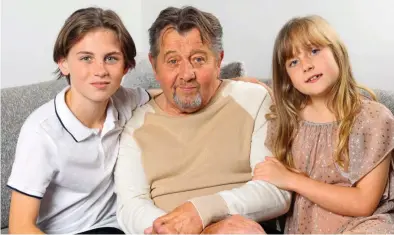  ?? ?? Grateful: John with grandchild­ren Johnny and Alice, who he has been able to see grow up