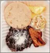  ?? WENDELL BROCK FOR THE ATLANTA JOURNAL-CONSTITUTI­ON ?? La Bodega’s Salvadoria­n plate is a hearty breakfast of a plain pupusa, scrambled eggs with cheese, curtido, plantains, and casamiento (mixed black beans and rice).