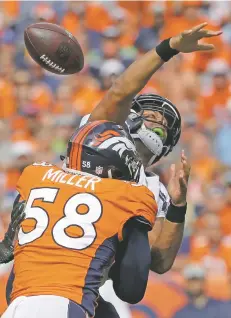  ?? JACK DEMPSEY/ASSOCIATED PRESS FILE PHOTO ?? Broncos linebacker Von Miller pressures Seahawks quarterbac­k Russell Wilson on Sunday in Denver. Miller had three sacks in the win. The week, the Broncos host the Raiders.