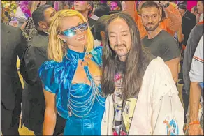  ?? John Katsilomet­es Las Vegas Review-journal @Johnnykats ?? Paris Hilton and Steve Aoki at the grand opening of Resorts World Las Vegas on Thursday. Hilton’s parents and sister also attended.