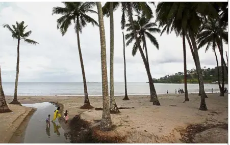  ??  ?? Isolated region: A file photo showing a group of Indian tourists walking on a beach on South Andaman Island near Port Blair, capital of the Andaman and Nicobar Islands. — AFP