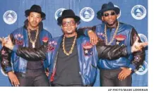  ?? AP PHOTO/MARK LENNIHAN ?? The rap group Run-DMC, from left, Joseph “Run” Simmons, Darryl “DMC” McDaniels, and Jason Mizell “Jam Master Jay,” poses at the 31st annual Grammy Awards in New York in 1988.