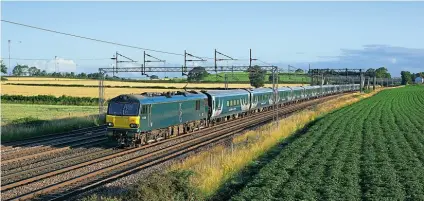 ?? ANDY MASON ?? The lighter summer mornings provide opportunit­ies to photograph the sleeper trains, and leading a rake of Mk5 sleeping cars, No. 92038 passes Grendon between Tamworth and Nuneaton with working 1M16, the Inverness to London Euston ‘Highlander’.
