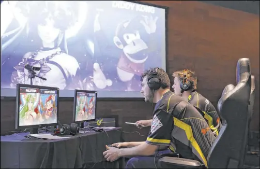  ?? Erik Verduzco Las Vegas Review-Journal @Erik_Verduzco ?? Las Vegas resident Dakota Goode, center, plays in the “Super Smash Bros. Ultimate” tournament in Las Vegas on Saturday.