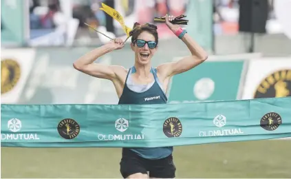  ?? Picture: Michel Bega ?? HAPPINESS IS. Ann Ashworth celebrates as she crosses the finish line to win the women’s race at the Comrades Marathon at Moses Mabhida Stadium in Durban yesterday.