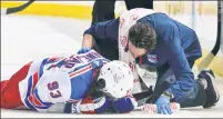  ?? Getty Images ?? CAN’T LOOK: Mika Zibanejad lays on the ice after colliding with Islanders defenseman Adam Pelech’s elbow on Tuesday night.