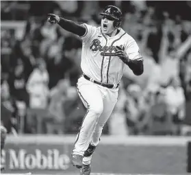  ?? Ashley Landis / Associated Press ?? The Braves’ Austin Riley reacts after hitting the game-winning RBI single in a 3-2 win over the Dodgers in Game 1 the National League Championsh­ip Series.