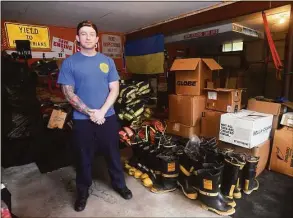  ?? Ned Gerard / Hearst Connecticu­t Media ?? Fire Lt. Konstantin Tartakovsk­y is shown Thursday in the garage of his Trumbull home with firefighti­ng equipment he has collected. A native of Ukraine, Tartakovsk­y is collecting the equipment and other supplies that will be shipped to Ukraine to assist relief efforts following the Russian invasion.