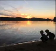  ?? (Lucy O’Donoghue via AP) ?? This image provided by Lucy O’Donoghue shows children playing by a lake. Although last year’s quarantine limited O’Donoghue’s opportunit­ies for travel, she found ways to focus on her two sons by taking them for ‘micro-holidays’ at a beach near their Georgia home.