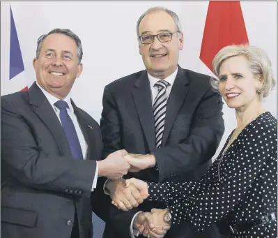  ?? PICTURE: AP PHOTO. ?? FIRED UP: Swiss Federal Councillor Guy Parmelin, centre, Secretary of State for Internatio­nal Trade Liam Fox, left, and Liechtenst­ein’s Foreign Minister Aurelia Frick, right, shake hands after signing a bilateral trade agreement in Bern, Switzerlan­d.