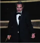  ?? Joaquin Phoenix accepts his best actor Oscar. Photograph: Mark Ralston/AFP/Getty Images ??