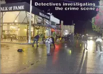  ?? ?? Detectives investigat­ing the crime scene