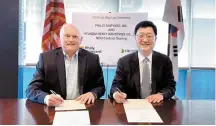  ?? Courtesy of HD Hyundai ?? Joo Won-ho, right, head of HD Hyundai Heavy Industries’ naval and special ship business unit, and Philly Shipyard CEO Steinar Nerbovik sign a memorandum of understand­ing at the latter’s office in Philadelph­ia, Pennsylvan­ia, April 12.