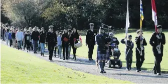  ??  ?? A procession of about 120 Grade 6 and 7 students from Rockheight­s Middle School, accompanie­d by Canadian Armed Forces members from CFB Esquimalt, takes part in ceremonies at God’s Acre.