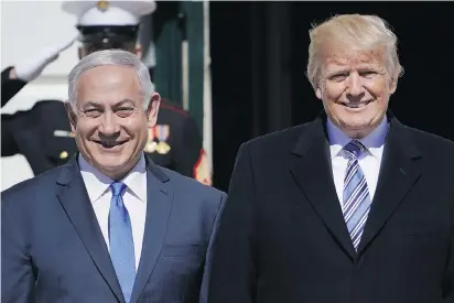  ?? MANDEL NGAN/AFP/GETTY IMAGES ?? Benjamin Netanyahu and Donald Trump have much in common: Both are unpopular at home and are under scrutiny for alleged misdeeds, either by them or people close to them, Andrew Cohen notes.