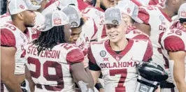  ?? JEFFREYMCW­HORTER/AP ?? Oklahoma’s SpencerRat­tler (7) is congratula­ted byRhamondr­e Stevenson (29) as he holds the Most Outstandin­g Player trophy on Saturday inArlingto­n, Texas.