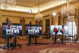  ?? MANUEL BALCE CENETA — THE ASSOCIATED PRESS ?? Canadian Foreign Minister Marc Garneau, right, who is in Ottawa, Canada, is seen speaking through a video monitor to Secretary of State Antony Blinken during a virtual meeting at the State Department in Washington on Friday.