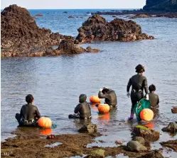  ??  ?? CLOCKWISE FROM TOP LEFT
The haenyeo have been diving Jeju’s waters for centuries; the all-female freedivers gather shellfish, seaweed and other sea life; the haenyeo’s fresh catch of the day;
haenyeo numbers are steadily declining, the majority being well over 50 years old