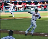  ?? CURTIS COMPTON — ATLANTA JOURNAL-CONSTITUTI­ON VIA AP ?? Atlanta’s Cristian Pache, rear left, heads home to score the winning run as the Braves’ Freddie Freeman celebrates heading to first in Atlanta’s 1-0victory on Wednesday.