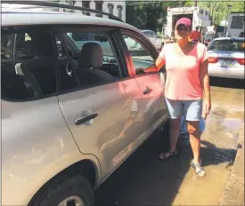  ?? EVAN BRANDT — MEDIANEWS GROUP ?? By Wednesday morning, Krista Detweiler, and her RAV 4, were back in front of her house for the big cleanup in the zero block of Walnut Street in Pottstown.