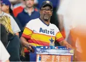  ?? Karen Warren/Staff photograph­er ?? Larry Cleary carries drinks to sell to fans during Monday’s Game 2 of the ALCS at Minute Maid Park.