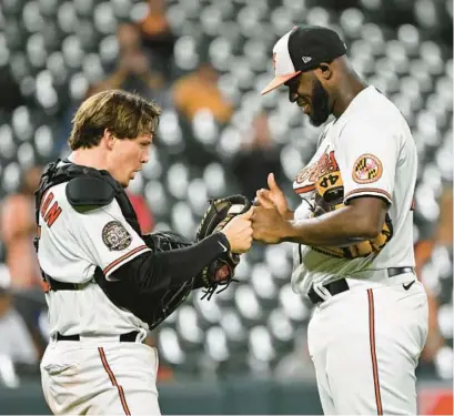  ?? TERRANCE WILLIAMS/AP ?? Orioles catcher Adley Rutschman, left, greets relief pitcher Felix Bautista after a win over the Blue Jays on Sept. 6. Through a combinatio­n of key acquisitio­ns, improved game-planning and players’ applicatio­ns of the team’s resources, Baltimore has built the majors’ most improved pitching staff of the past nine decades.