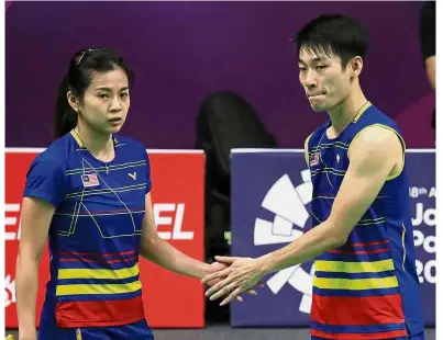  ??  ?? Sorry mate: Malaysian mixed doubles pair Chan Peng Soon (right) and Goh Liu Ying console each other after losing to Hong Kong’s Lee Chun Hei-Chau Hoi Wah at the Istora Bung Karno Stadium yesterday.