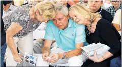  ?? PATRICK SEMANSKY/THE ASSOCIATED PRESS ?? Carl Hiaasen (centre) brother of Rob Hiaasen, one of the journalist­s killed in the shooting at The Capital Gazette newspaper offices, is consoled by his sisters Barb, (left) and Judy during a memorial service July 2 in Owings Mills, Md.