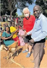  ?? CONTRIBUTE­D ?? Eddie Joyce is presented a goat as a thank you from villagers.