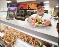  ?? Brian A. Pounds / Hearst Connecticu­t Media ?? Rich Sandmann, general manager and culinary innovation specialist from Whitsons Culinary Group, introduces Teriyaki Tofu Rice Bowl Veggabols, one of 10 rotating plant-based menu offerings available daily at Shelton High School, on Thursday.