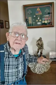  ?? PILOT NEWS GROUP PHOTO/ANGELA CORNELL ?? Arthur Woolington, is a WWII veteran and will be celebratin­g his 102 birthday on Wednesday. He is pictured here along with some of his war regalia, a statue commemorat­ing his service, and a picture from his trip with Honor Flight on April 30, 2014.