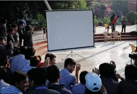  ??  ?? REPRESENTA­TIONAL PICTURE: Students use mirrors to cast reflection­s of partial solar eclipse on a screen as they observe the eclipse in Ahmedabad, on Thursday. REUTERS