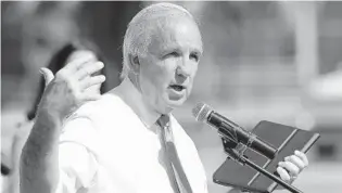  ?? WILFREDO LEE/AP ?? Miami-Dade County Mayor Carlos Gimenez gestures as he speaks during a news conference announcing the opening of some county facilities Monday in Miami.