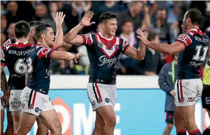  ?? MATT KING/GETTY IMAGES ?? Joseph Manu celebrates with his team mates after scoring his try in the grand final.
