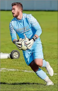  ?? DANA JENSEN/THE DAY ?? Mitchell College goalie Seth Strader takes control of the ball during a soccer match against Eastern Connecticu­t last season in New London. Strader, an NFA graduate, is one of five finalists for the New England Collegiate Conference male senior student-athlete of the year award.