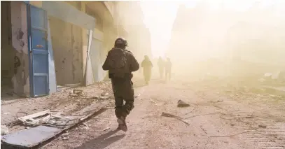  ?? (IDF) ?? MAJOR ORI GETTER brings up the rear during a patrol with his troops in the Gaza Strip.