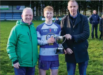  ??  ?? Eugene Dooley and County Chairman Martin Fitzgerald present Blessingto­n captain Brian Bohan with the under-20 ‘B’ football championsh­ip cup.