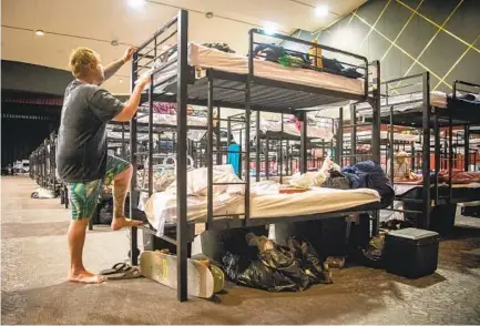  ?? JARROD VALLIERE U-T ?? Teak Hawksford climbs into his bunk at the Golden Hall shelter for the homeless in downtown San Diego on Tuesday.