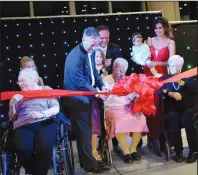  ?? NEWS FILE PHOTO ?? Mayor Ted Clugston cuts ribbon to formally open the city's newest retirement residence in December, with Masterpiec­e's very first resident Margaret Clementi. Also pictured are resident Edith Giesbrecht, Sarah Garforth-Bles, Sofia Garforth-Bles, Tim...