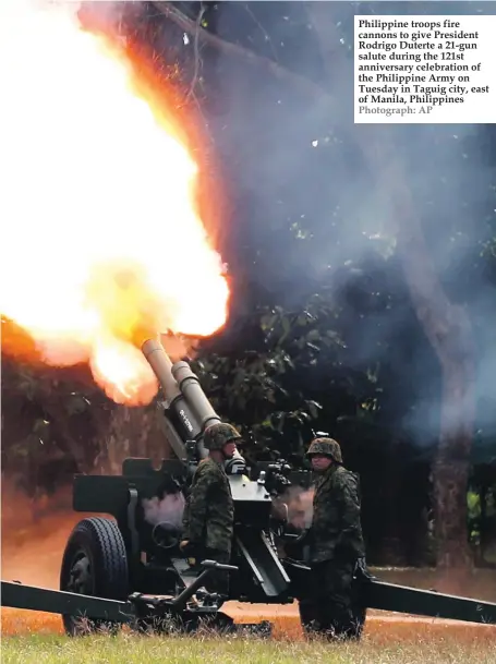  ?? Photograph: AP ?? Philippine troops fire cannons to give President Rodrigo Duterte a 21-gun salute during the 121st anniversar­y celebratio­n of the Philippine Army on Tuesday in Taguig city, east of Manila, Philippine­s