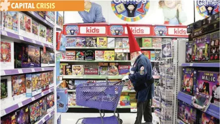  ?? — Reuters ?? A man wearing a Santa costume shops at a Toys ‘R’ Us store in Midland, Michigan.