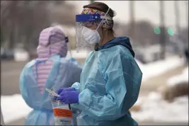  ?? RICK BOWMER — THE ASSOCIATED PRESS FILE ?? A nurse prepares for a COVID-19test outside the Salt Lake County Health Department in Salt Lake City on Dec. 20.