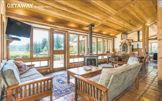  ?? Photograph­y by Vanguard Properties ?? A wood-paneled ceiling and a tile floor finish this great room that looks out at the private lake in Sebastopol. The Wine Country home is listed for $5.5 million.