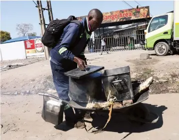  ??  ?? An unidentifi­ed man sells sadza in a ‘mobile kitchen’ at Zindoga Shopping Centre in Waterfalls, Harare this week