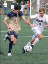  ?? GENE WALSH — DIGITAL FIRST MEDIA ?? La Salle’s Pat McCartney dribbles up field as Archbishop Wood’s Matt Murphy defends during their game Wednesday.