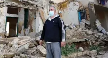  ?? AFP ?? Civil war survivor Jean Saliba is pictured in front of buildings damaged by the Aug. 4 Beirut port blast in the Karantina district of the Lebanese capital.