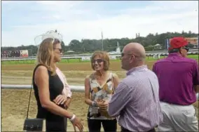  ?? JOSEPH PHELAN —JPHELAN@DIGITALFIR­STMEDIA.COM ?? SUNY Empire State alumni, students and staff gathered in the winner’s circle during the fourth race Friday afternoon.