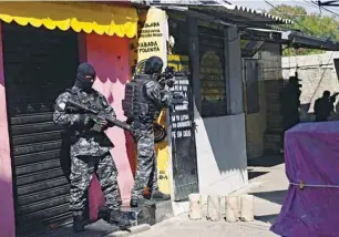  ??  ?? Officers are seen during an operation against drug trafficker­s at the Jacarezinh­o favela in Rio de Janeiro.