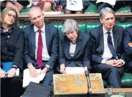  ??  ?? Clockwise from main picture: anti-Brexit protesters demonstrat­e in front of the Houses of Parliament yesterday; Brexit Minister Stephen Barclay leaves Downing Street, and Theresa May listens to a question during Prime Minister’s Questions in the House of Commons